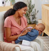 Women holding baby in nursery